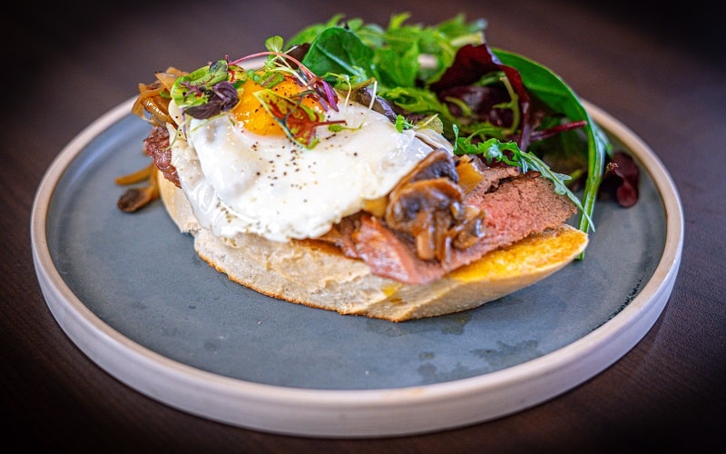 Bookmaker sandwich with sirloin steak, confit mushroom, onion and fried egg
