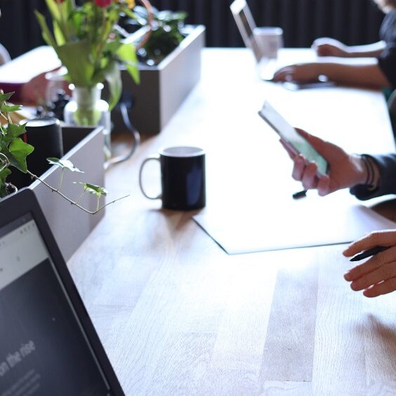 Close up of people sat at a desk working