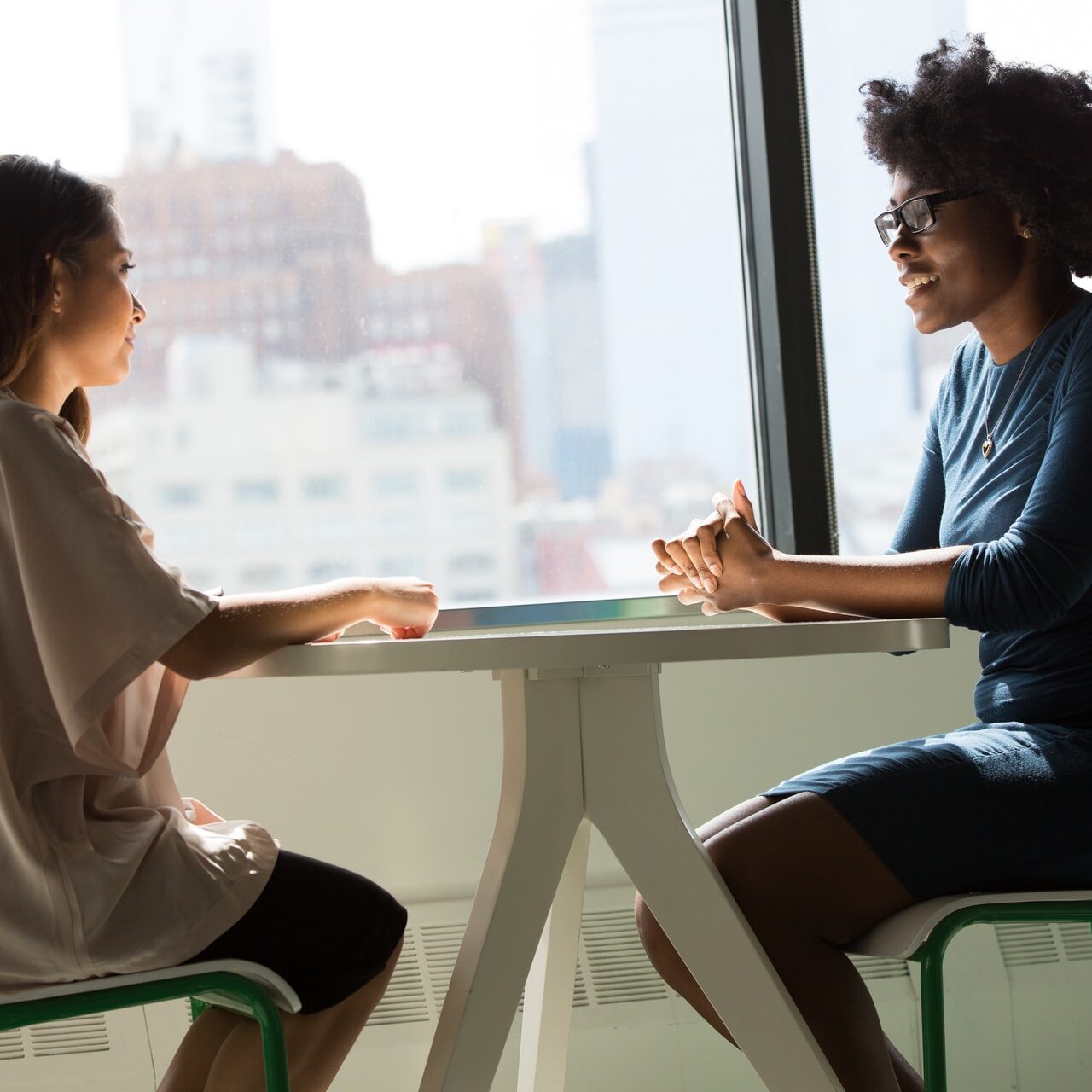 2 women talking at table